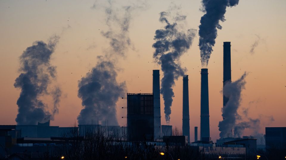 Smoke coming out of factory chimneys.