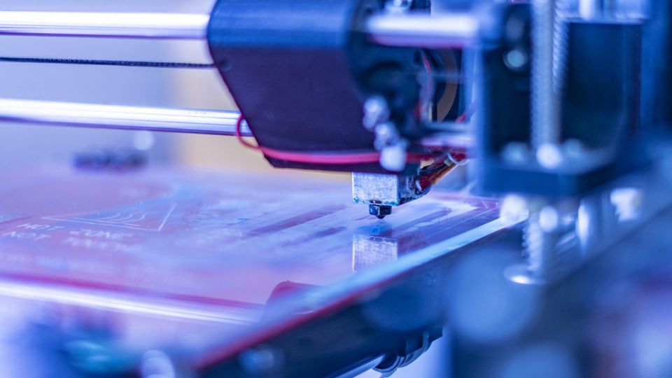 Close-up of a 3D printer nozzle in action, highlighting precision technology for bioprinting applications.