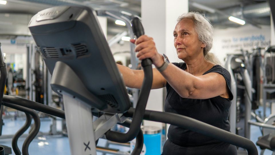 An older women working out in the gym.