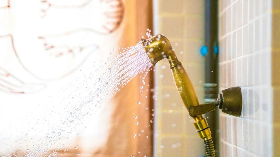 A showerhead sprays water.