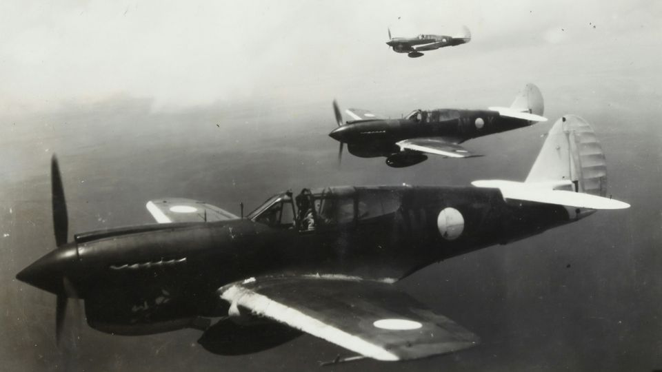 Three world war 1 planes flying in the sky.