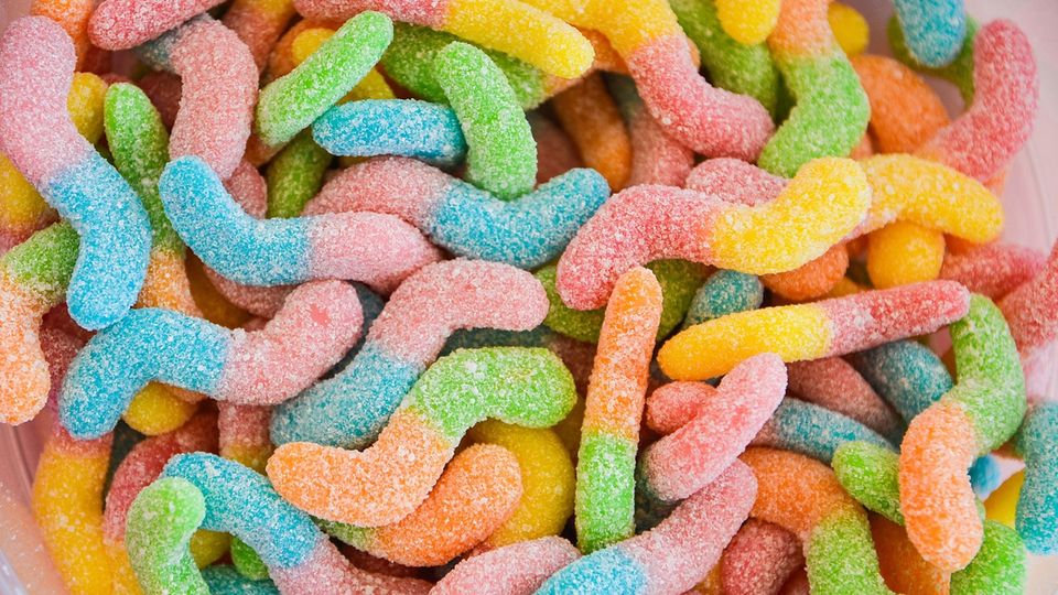 Multicolored, sugar-coated gummy worms.