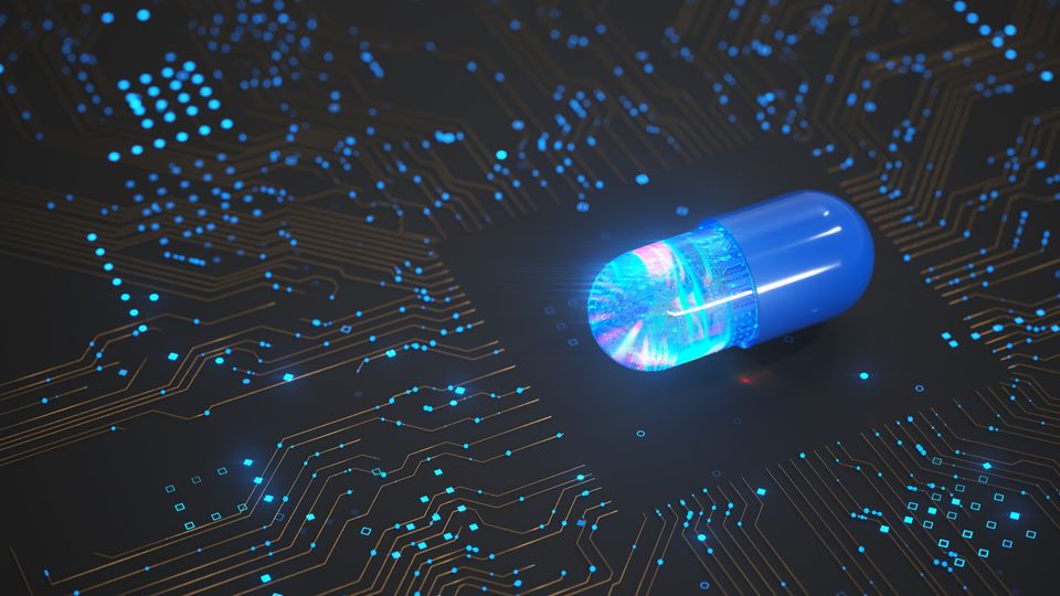 A blue capsule sitting on top of a computer chip.