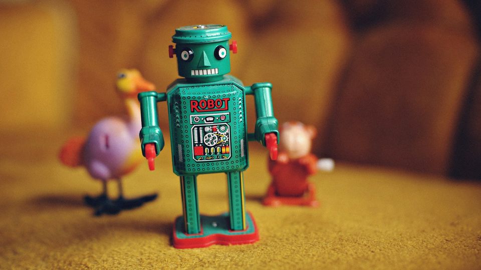 A green and multicolored robot figurine.