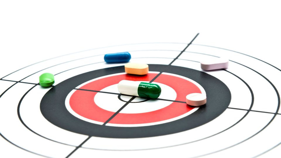 Drug molecules resting on a bullseye.