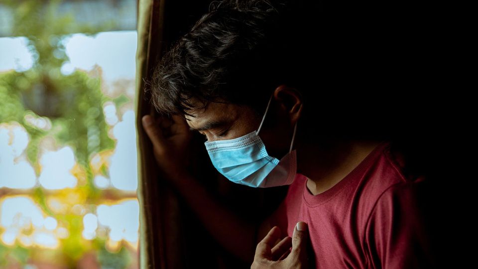 Individual wearing a face mask.