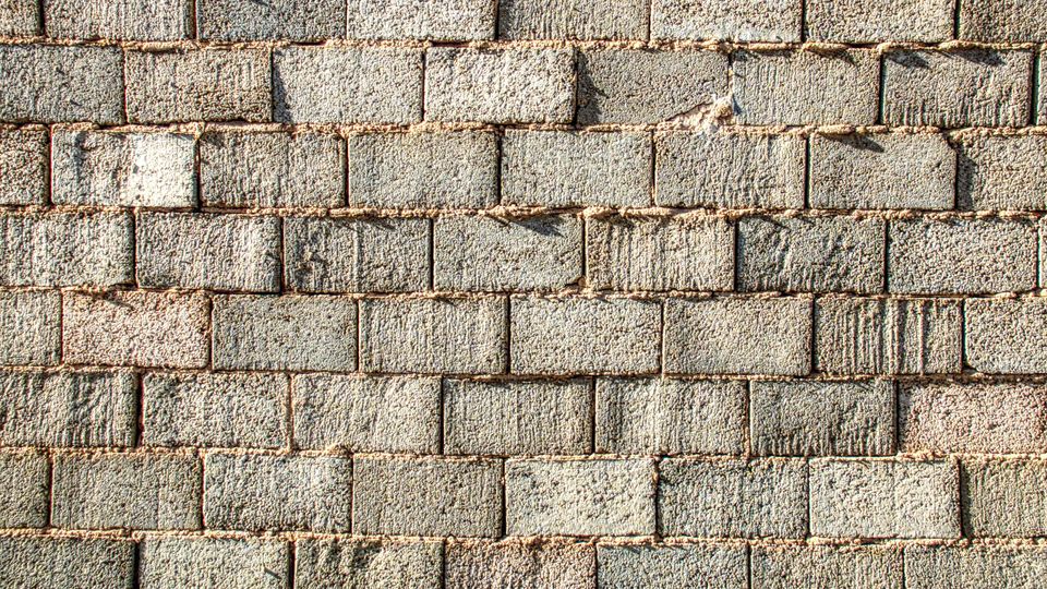 A grey cement brick wall.