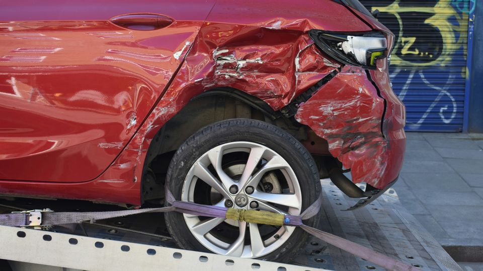The crumpled rear of a car after a minor crash.