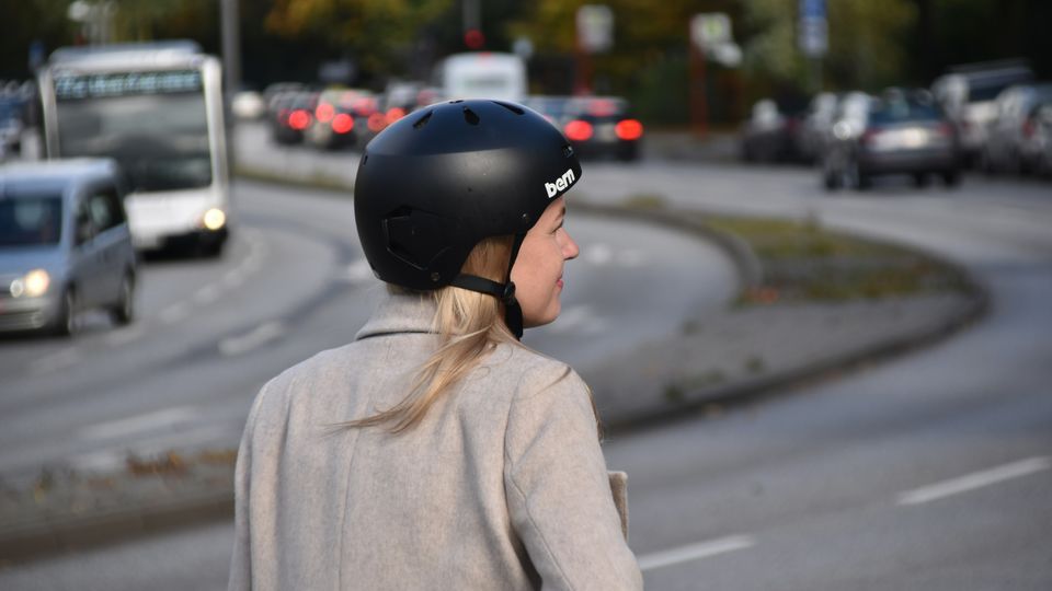 A woman wears a cycle helmet