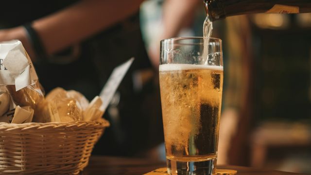 Beer being poured from a bottle into a glass.
