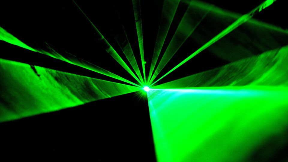 Green laser light shining toward the camera.