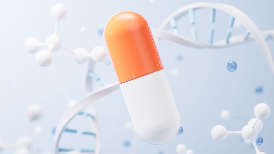 Orange and white drug capsule with DNA and molecules in background.