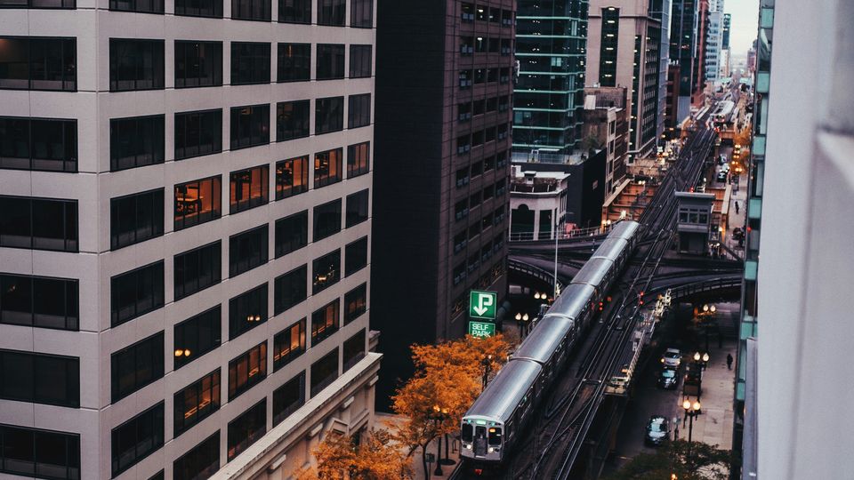 A train in Chicago between skyscrapers.