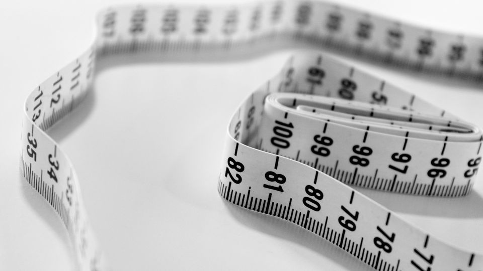 A black and white measuring tape used to measure weight loss.