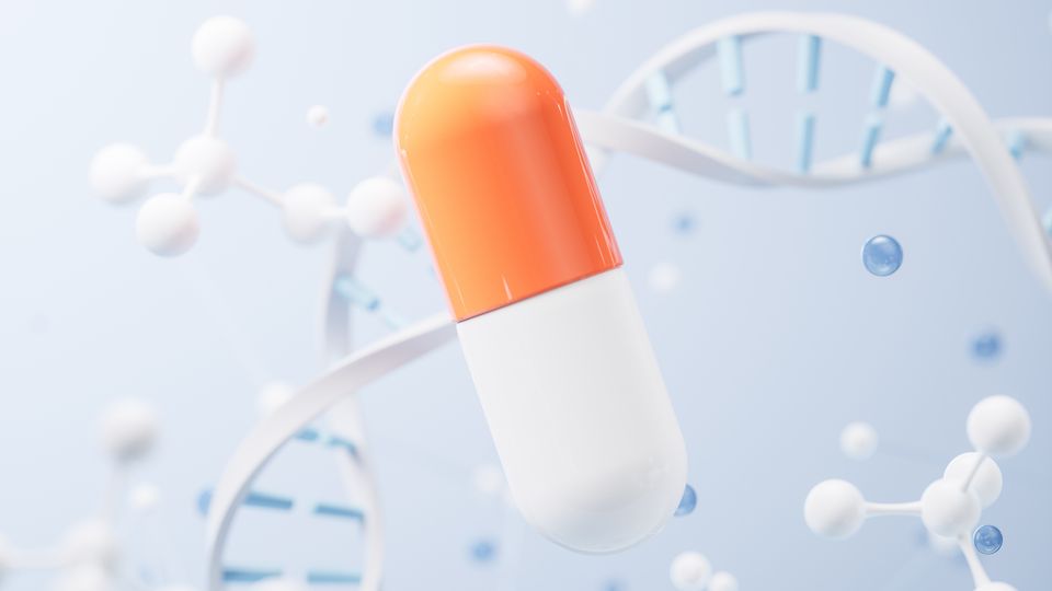 An orange and white drug capsule, floating against a blue background with white DNA and molecule shapes floating in the background.