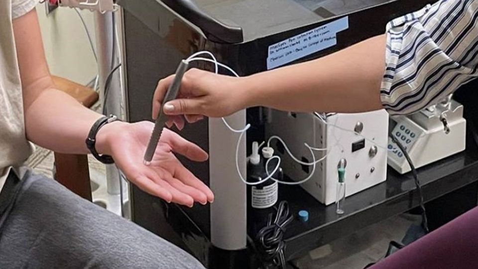 Image of MasSpec Pen being tested on human hand.