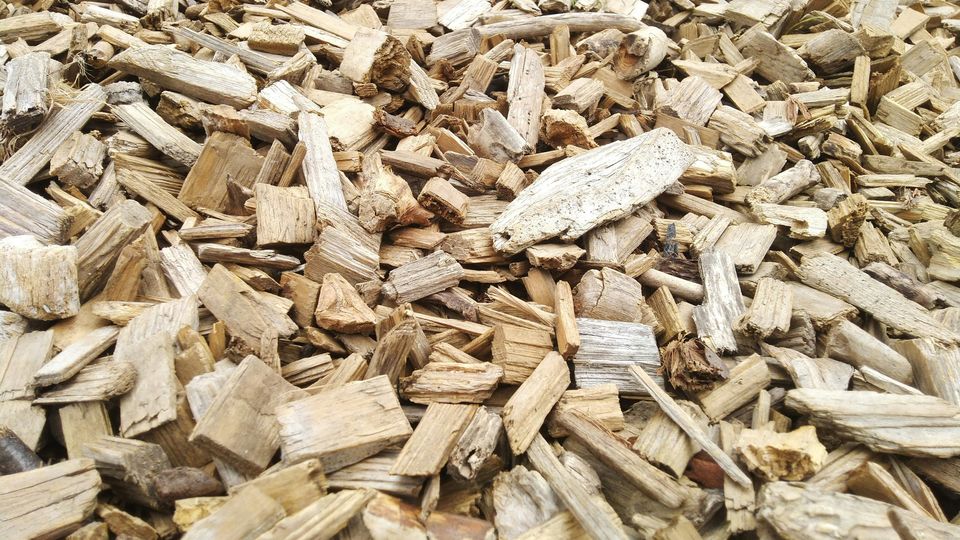 Large chunks of woodchip in a pile.