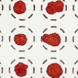 Close-up of dried blood spots on filter paper within printed collection circles for analysis.