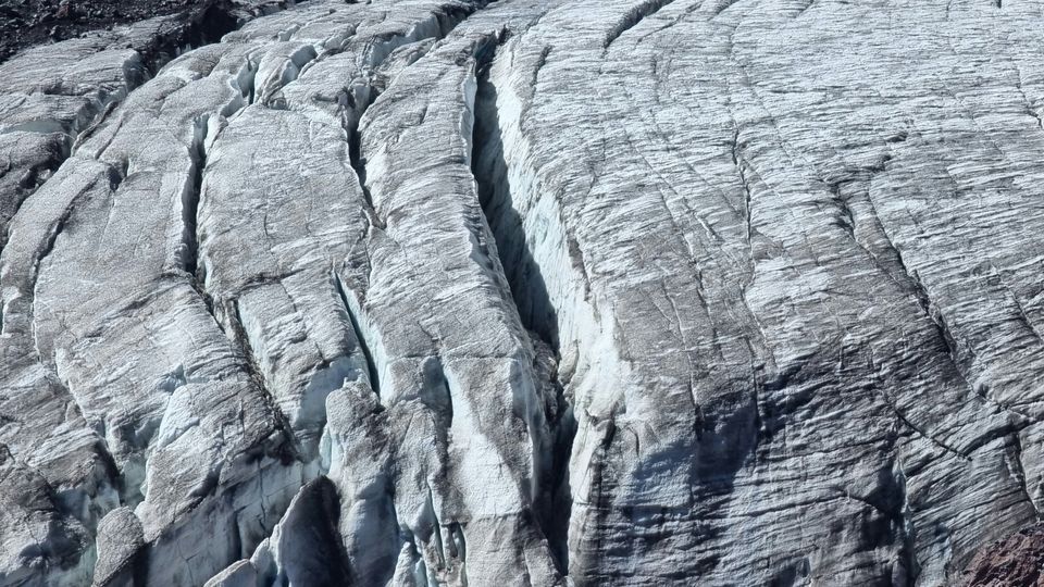 A glacier with a large gap in the centre of the photograph.