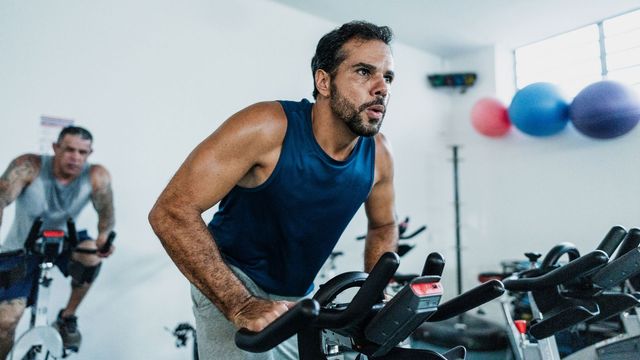 Man exercising on an indoor spin bike. 