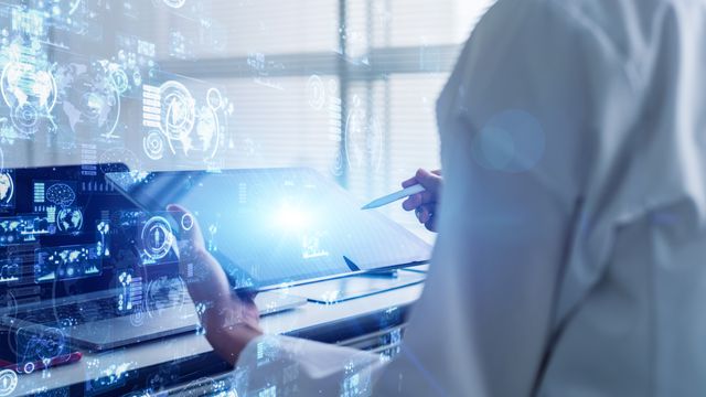 Scientist using digital tablet with virtual data interface, representing a LIMS platform.