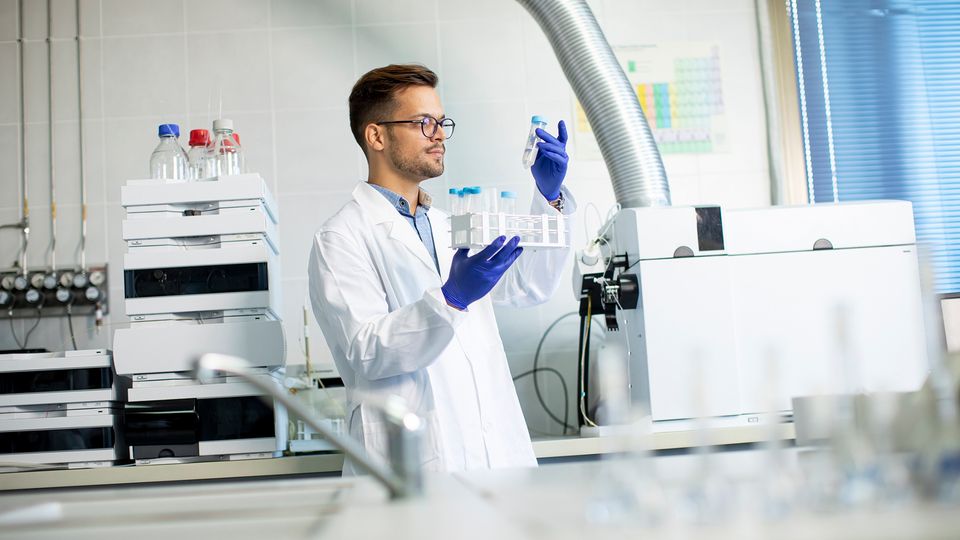A scientist in a laboratory using a chromatograph.