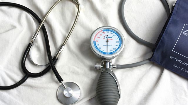 A stethoscope next to a blood pressure measurement device.