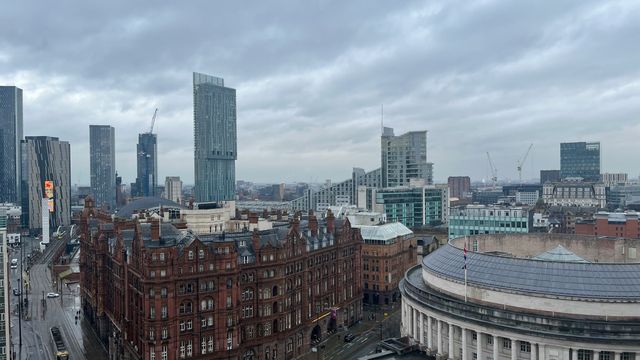 The skyline of Manchester, modern skyscrapers and older, Victorian buildings.