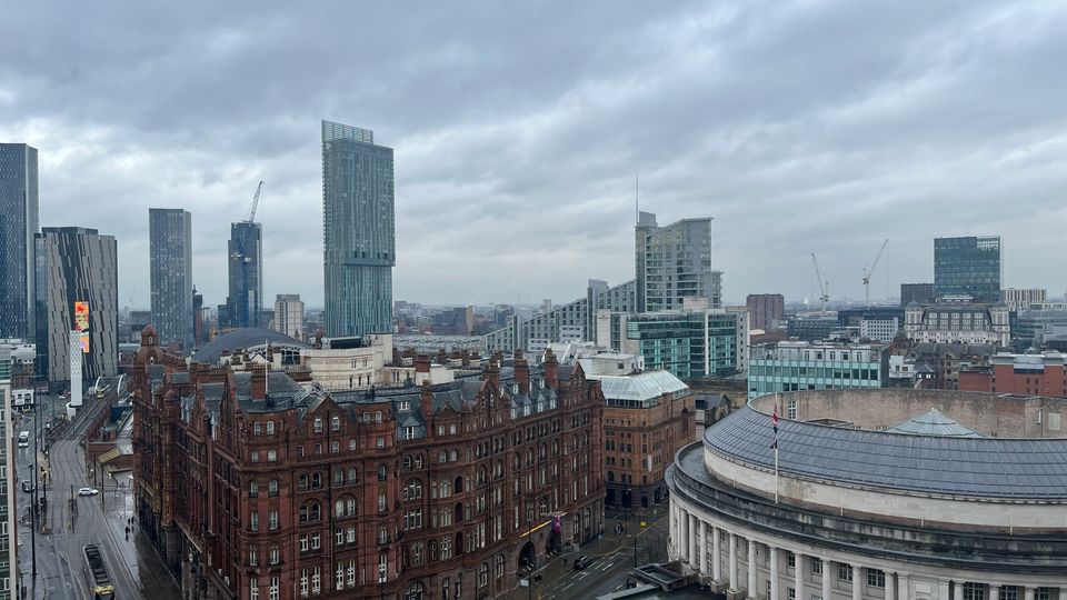 The skyline of Manchester, modern skyscrapers and older, Victorian buildings.