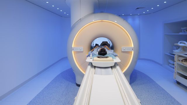 Patient undergoing magnetic resonance imaging scan inside a modern MRI machine in a hospital. 