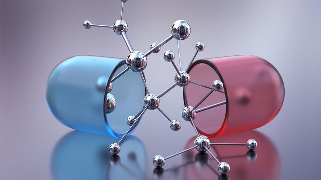 A red and blue pill split into two with a model of a drug molecule in the middle.