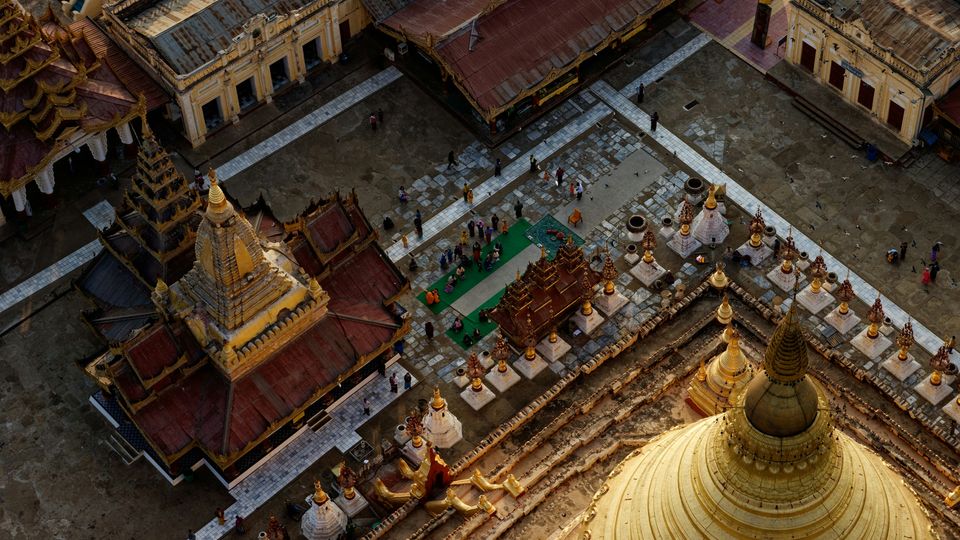 The Shwezigon Pagoda, Myanmar. A shot from above. Small group of people visible.