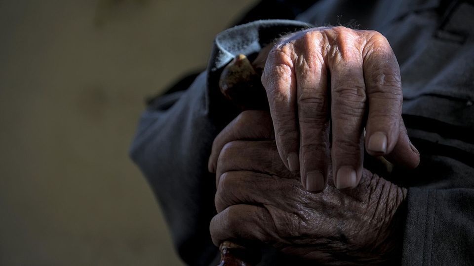 An older persons wrinkled hands.
