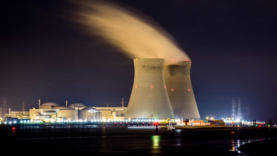 A nuclear reactor facility at night.