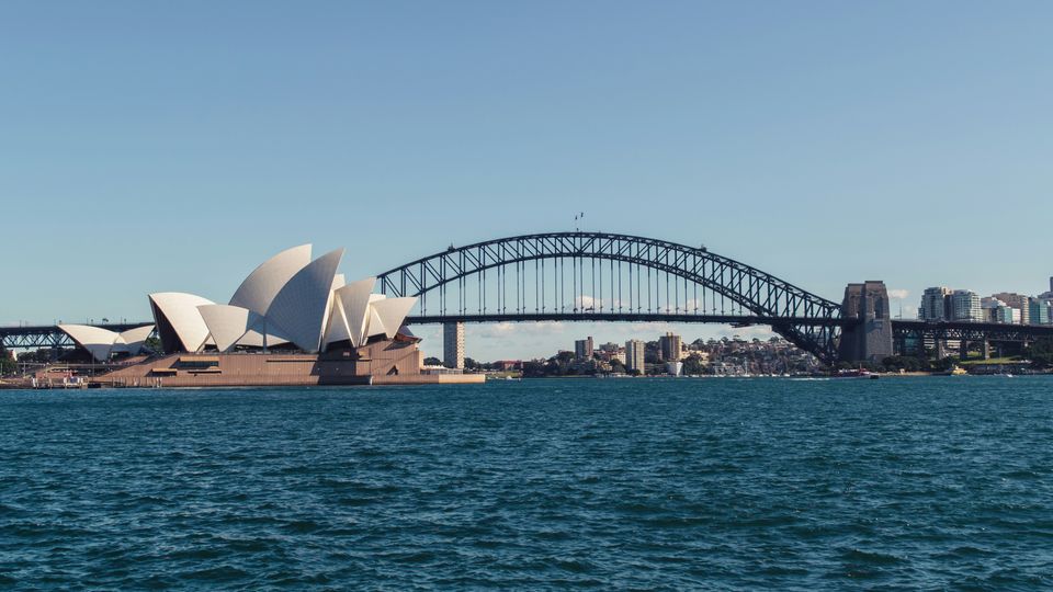 A view of Sydney harbour, its bridge, the opera house, the water.