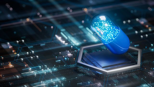Blue digital pill capsule hovering over a futuristic circuit board representing a medical digital twin.