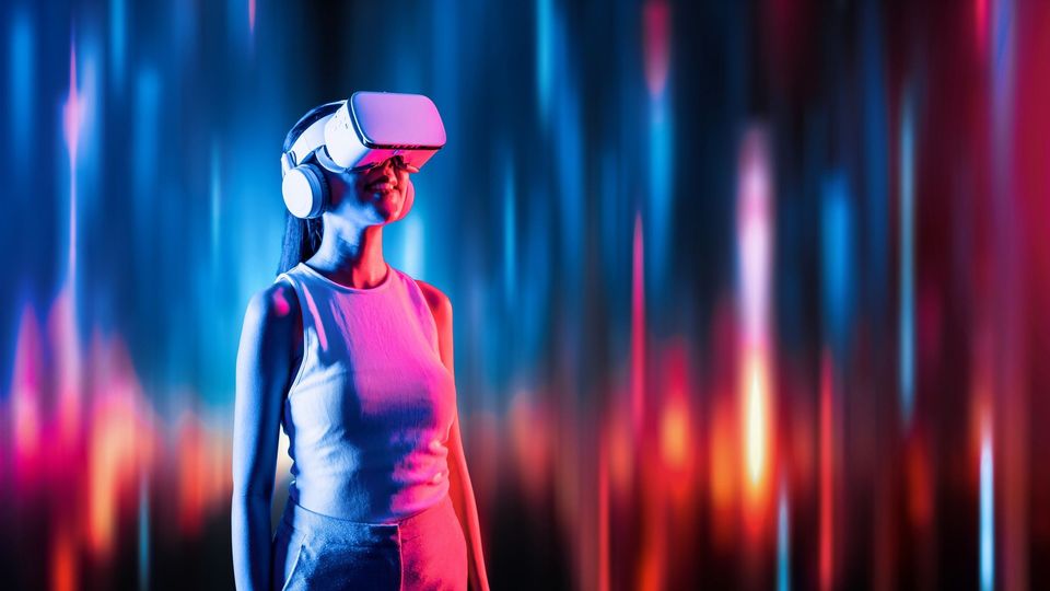 Smiling woman wearing a VR headset, immersed in a vibrant virtual reality experience.