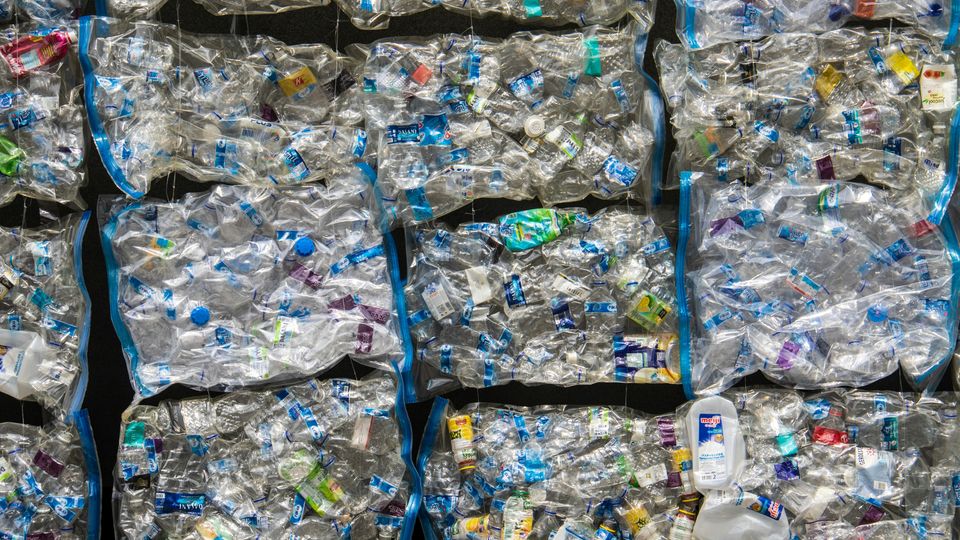Large square bags containing plastic bottles.