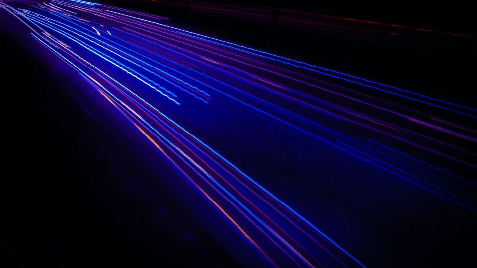 Thin blue light trails, stretching from the top-left to the bottom-right of the image.
