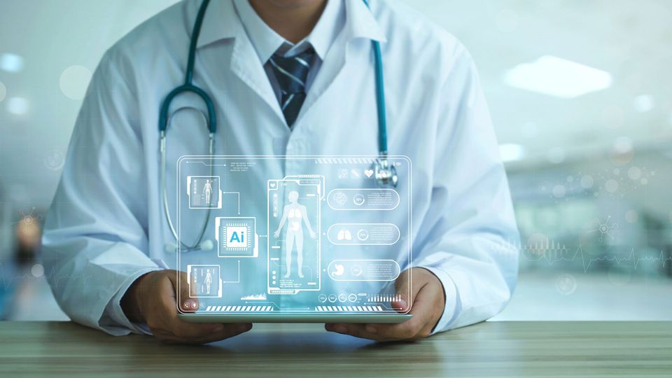 A doctor holding up a small tablet with a hologram floating above it, that shows the letters "AI" and an assortment of different medical images.
