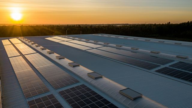 Solar panels on a roof at sunset.
