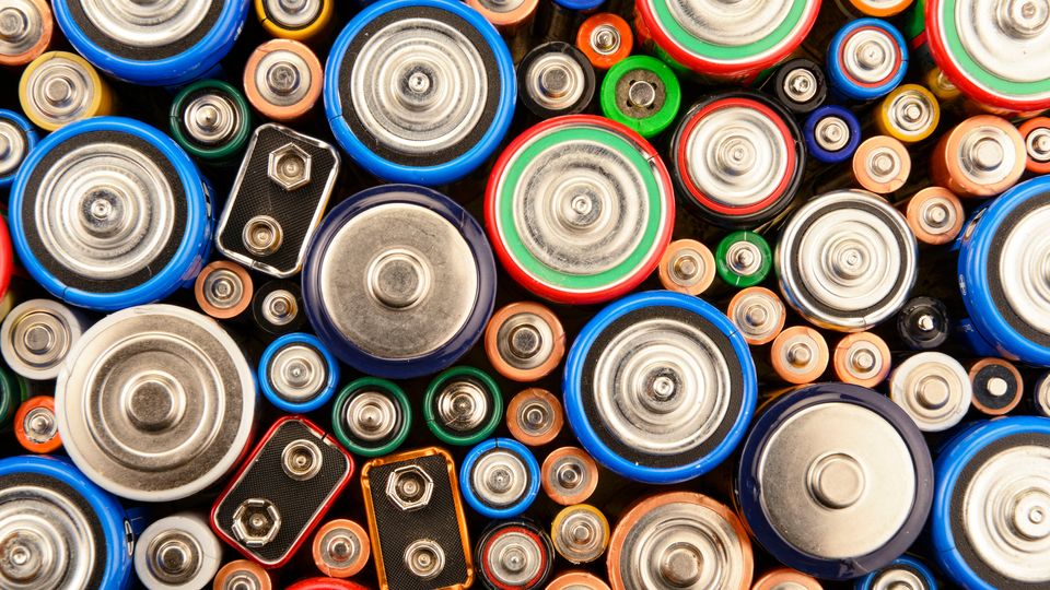 A top-down photograph of many different types and sizes of battery, standing on their end.