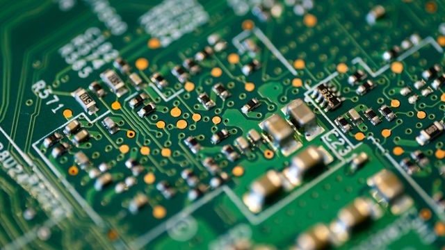 A green and gold computer motherboard. 