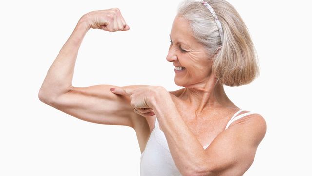 Older lady flexing her muscles. 