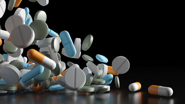 A cascade of various types of drug pills.