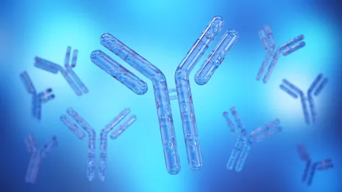 3D illustration of antibodies on a blue background, representing innovation and efficiency in continuous antibody manufacturing.