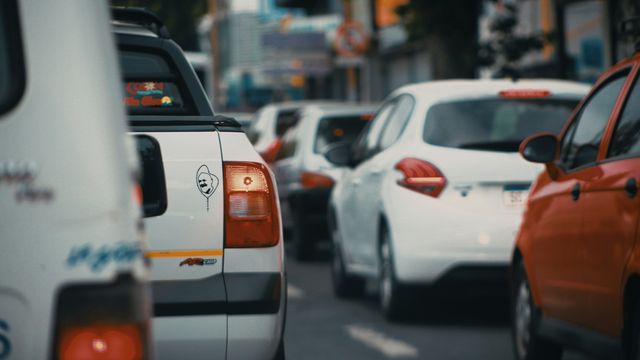 Rows of white taxis, stuck in traffic.