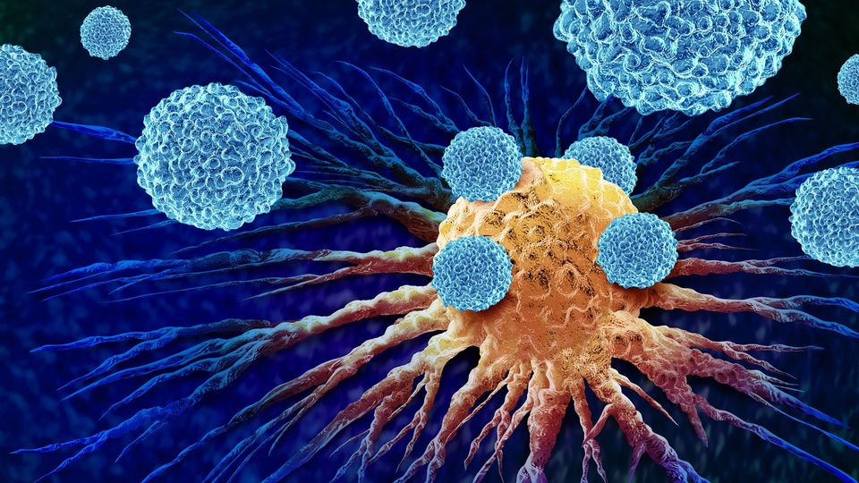 A digital illustration of blue ball-shaped particles attacking an orange cancer cell.