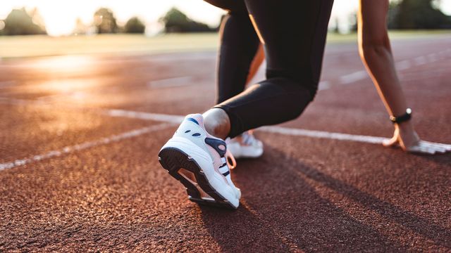 A female runner at the starting line of a race. 
