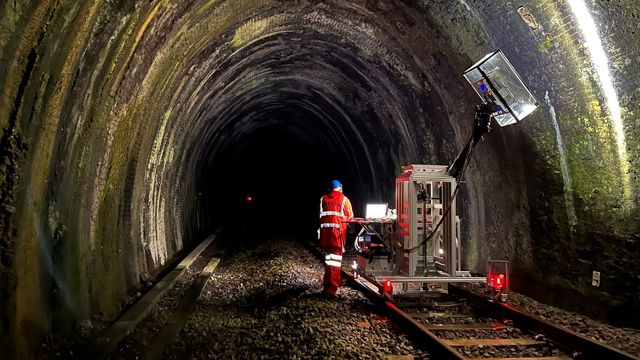 The imaging rig being wheeled along a dark section of a railway tunnel. 